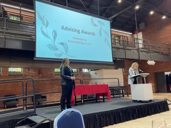 Picture of Dava being presented with award at the Awards Celebration