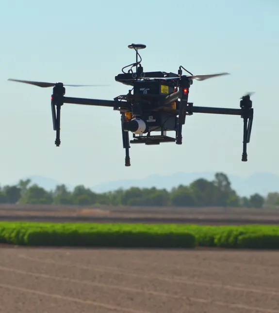 Drone flying over field