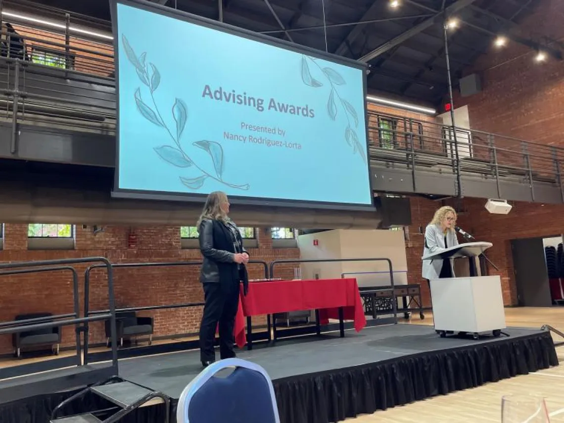 Picture of Dava being presented with award at the Awards Celebration